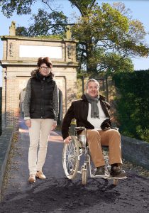 Woman next to man in wheelchair